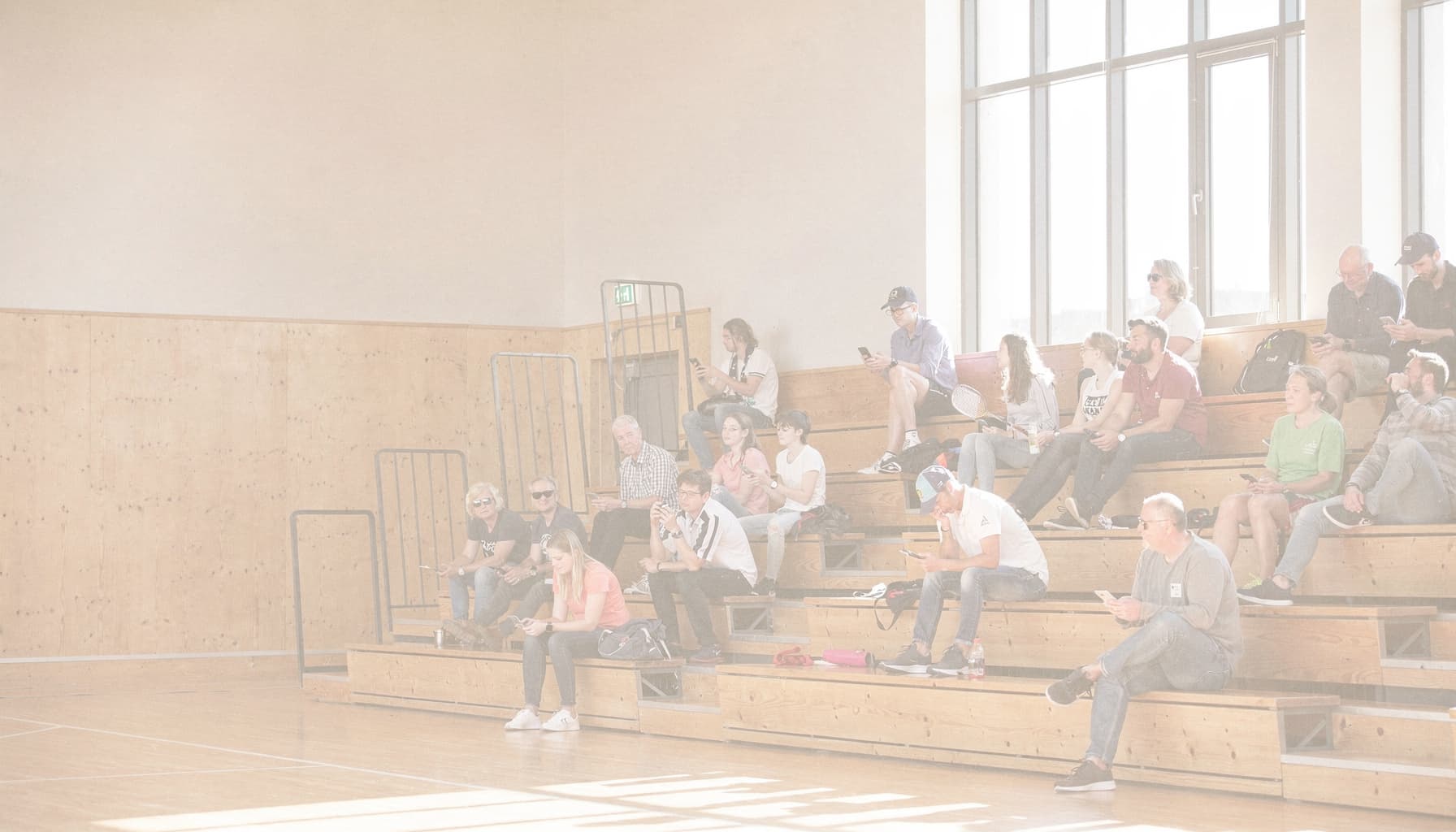 Spectators on bleachers in a sports hall